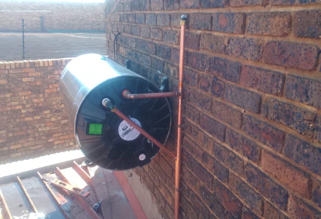 Image of a geyser installation on a brick wall